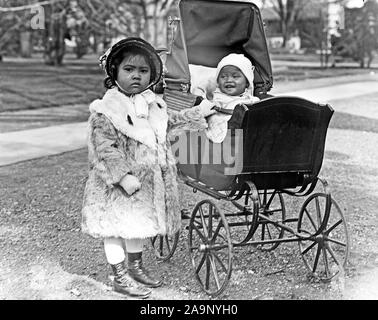 Early 1900s - Little child and baby in her baby stroller ca. 1913-1917 Stock Photo