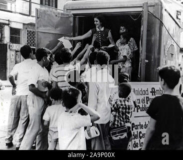 A U.S.I.S. employee distributes mimeographed leaflets describing plans for bookmobile.An estimated 5,000 leaflets were distributed in Santa Ana Plaza. Stock Photo