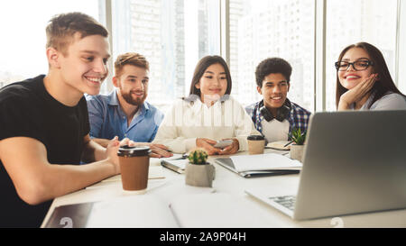 Tutorial video. Students using laptop in university library Stock Photo