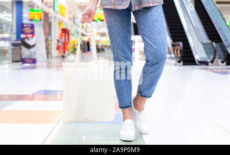 Eco shopping. Girl holding blank cotton bag for your design Stock Photo