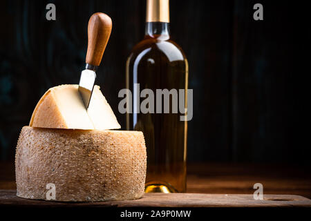 Piece Cut from Whole Matured Cheese Wheel. Traditional Food Produce. Stock Photo