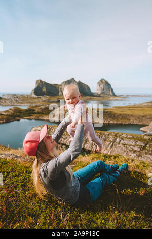 Mother with infant baby traveling together enjoying mountains view family lifestyle mom and child active vacation lifestyle outdoors Mothers day Stock Photo