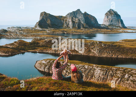 Happy family with baby relaxing outdoor travel vacations couple mother and father  with child adventure lifestyle trip in Norway Helgeland islands Stock Photo