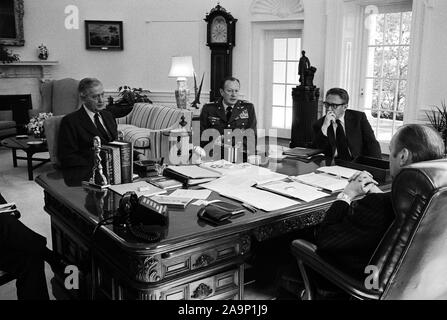 This photograph was taken in the Oval Office of the White House. Pictured with President Ford are Brent Scowcroft, Deputy Assistant to the President for National Security Affairs; Graham Martin, United States Ambassador to the Republic of Vietnam; Army Chief of Staff General Frederick Weyand; and Secretary of State Henry A. Kissinger.  Gerald Ford has his back to the camera. Brent Scowcroft is partially obscured. Stock Photo