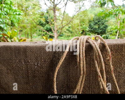 Hemp sack and rope on wall Stock Photo