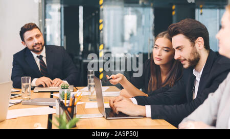 Business colleagues brainstorming and using laptop in office Stock Photo