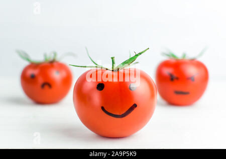 different emotions on tomatoes. Joy. Anger Sadness Despair Stock Photo