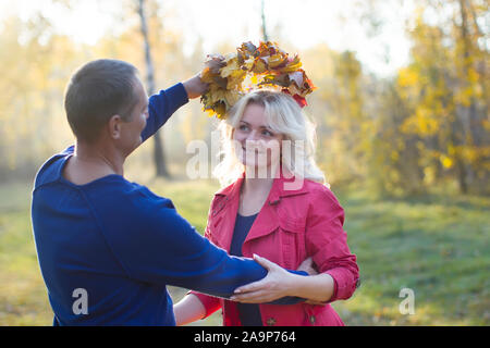 Loving couple in the autumn park. Spouses of middle age for a walk.Men and women hugging outdoors close up Stock Photo