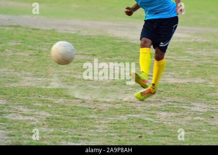 Soccer player is kicking ball during football practice in field Stock Photo