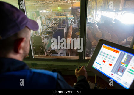 Belarus, the city of Gomil on April 29, 2019. Wood processing plant.Wood processing industry. Wood cutting shop. Worker at the computer controls the c Stock Photo