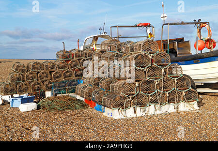 Stacks of crab pots stored by inshore fishing boats on the North Norfolk coast at Cley-next-the-Sea, Norfolk, England, United Kingdom, Europe. Stock Photo