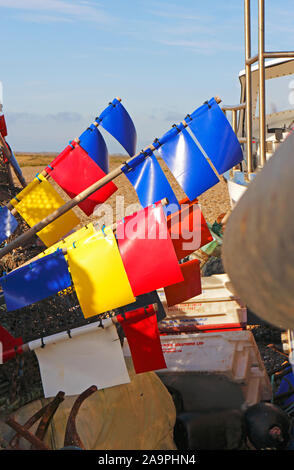 Red fishing buoy flags on bamboo poles in a Danish harbour Stock Photo -  Alamy