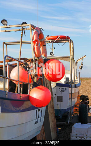 Red buoys hanging from the side of an inshore fishing boat in North Norfolk at Cley-next-the-Sea, Norfolk, England, United Kingdom, Europe. Stock Photo