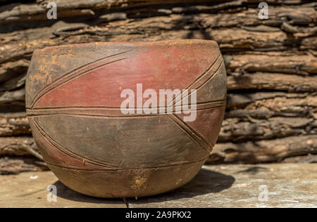 Old and dirty handcrafted clay bowl isolated in an outdoor setting image with copy space in a horizontal format Stock Photo