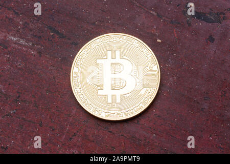 Golden bitcoin on red background. Cryptography, currency concept. Stock Photo