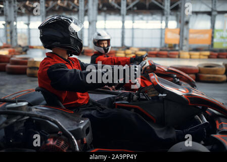 Two kart racers fight for victory, side view Stock Photo