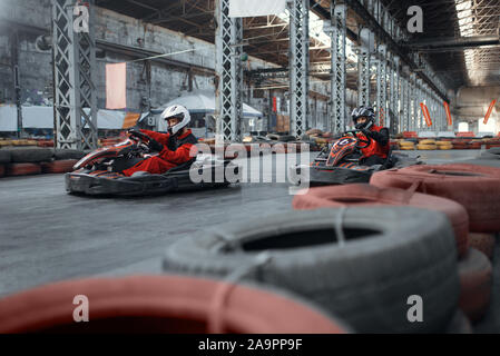 Two kart racers enters the turn, front view Stock Photo