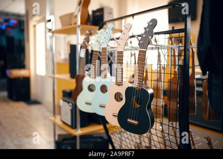 Ukulele guitars on showcase in music store Stock Photo
