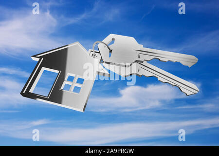 3D key ring with house pendant on sky background Stock Photo