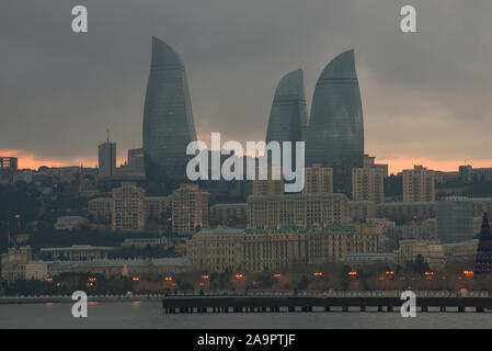 BAKU, AZERBAIJAN - JANUARY 04, 2018: Flame Towers over modern Baku on a gloomy January evening Stock Photo