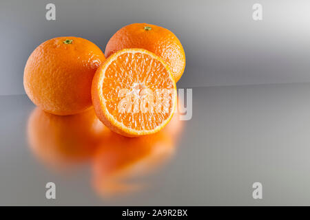 An image of three clementines on grey Stock Photo