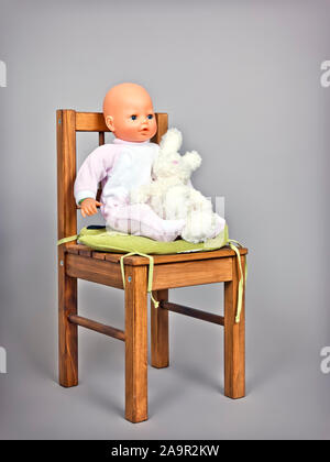 An image of a baby puppet on a chair Stock Photo