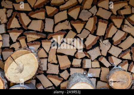 Texture of firewood and logs in cut. Firewood neatly stacked. Fireplace supplies for warmth and comfort. Stock Photo