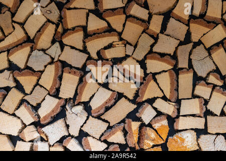 Texture of firewood and logs in cut. Firewood neatly stacked. Fireplace supplies for warmth and comfort. Winter readiness. Stock Photo