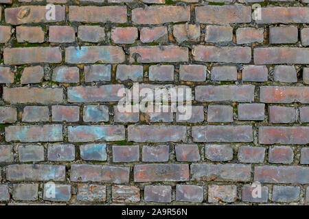 Old brickwork. Classic wall texture. Brick wall with moss between the bricks. Rough brick texture Stock Photo