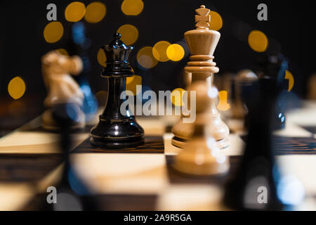 Close up of chess pieces on a chess board, representing strategy and tactics Stock Photo