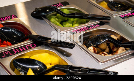 Slices of mango, kiwi, cherry in containers. Stock Photo