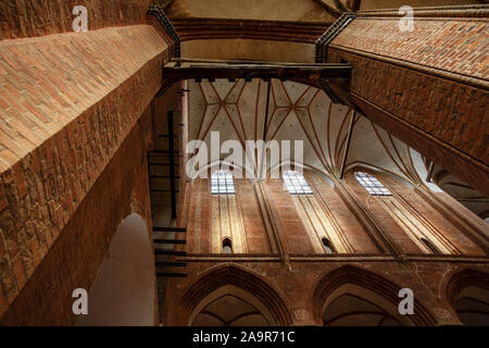 Brick vault with arches and pillars inside the St. Georgen Church in the old town of Wismar, famous tourist attraction Stock Photo