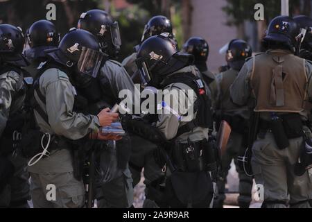 Hong Kong, CHINA. 17th Nov, 2019. Riot Police replenish tear-gas cans during clash with the student protesters outside Hong Kong Polytechnic University.Nov-17, 2019 Hong Kong.ZUMA/Liau Chung-ren Credit: Liau Chung-ren/ZUMA Wire/Alamy Live News Stock Photo