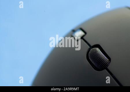 Ergonomic black mouse detail view on blue background Stock Photo
