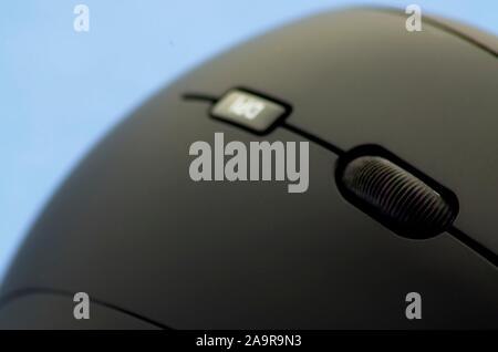 Ergonomic black mouse detail view on blue background Stock Photo