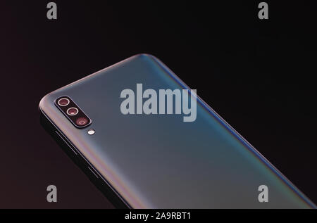 Modern smartphone with three lens camera close up. Stock Photo