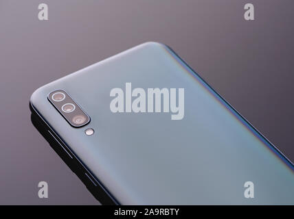 Modern smartphone with three lens camera close up. Stock Photo
