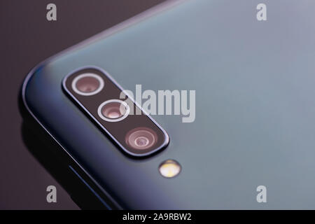 Closeup camera with three lenses of a modern smartphone. Stock Photo