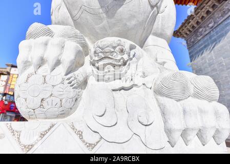 Stone-Carved Lion Guardian Sculpture at Guandu Ancient Town Stock Photo