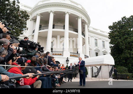 President Donald J. Trump talks to members of the press on the South Lawn of the White House Friday, Oct. 25, 2019, prior to boarding Marine One to begin his trip to South Carolina. Stock Photo