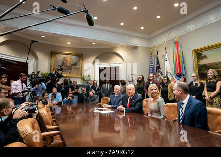 President Donald J. Trump, joined by Vice President Mike Pence, Presidential Advisor Ivanka Trump, and NASA Administrator Jim Bridenstine, talks via video tele-conference with NASA astronauts Jessica Meir and Christina Koch during the first all-women’s spacewalk Friday, Oct. 18, 2019, from the Roosevelt Room of the White House. Stock Photo