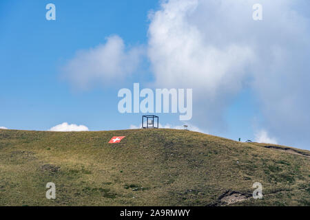 Aerial drone shot of cross of suspended cube by Jaya Schurch and swiss flag on Monte Tamaro Stock Photo