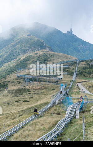 Ticino, Switzerland - August 5, 2019: Tourists enjoy bobsleigh coaster on the hills of Monte Tamaro Stock Photo