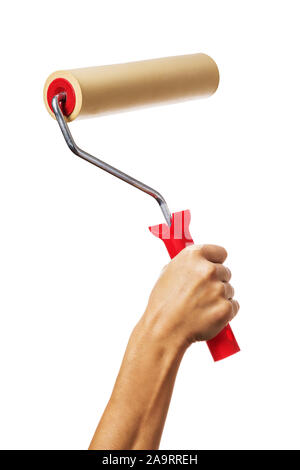 A raised female hand holds a roller to align the wallpaper. Worker with tool isolated on white background Stock Photo