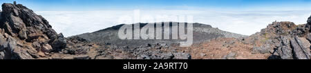 Large panoramic view of the pit crater at the top of the stratovolcano Mt Pico, Azores, taken from its pinnacle at 2351m above sea level. Stock Photo