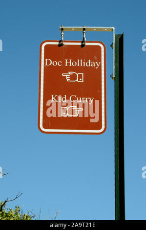 Signs at the Linwood Cemetery on a hillside above Glenwood Springs in Colorado. The signs point visitors to the graves of Doc Holliday and Kid Curry. Stock Photo