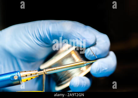 soldering iron with solder on a black background. electrical. electronics Stock Photo