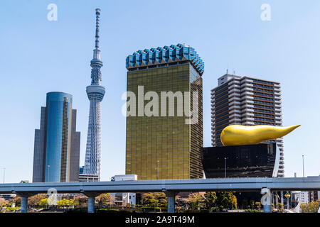 The Tokyo Skytree viewed from Asakusa with the Asahi Beer headquarters, AKA Asahi beer hall with the black brewery and golden flame in foreground. Stock Photo