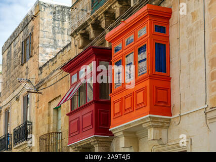 Two Maltese wooden balconies, red and orange Stock Photo