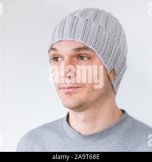 Cool man in winter fashion. Wearing scarf and knit hat Stock Photo